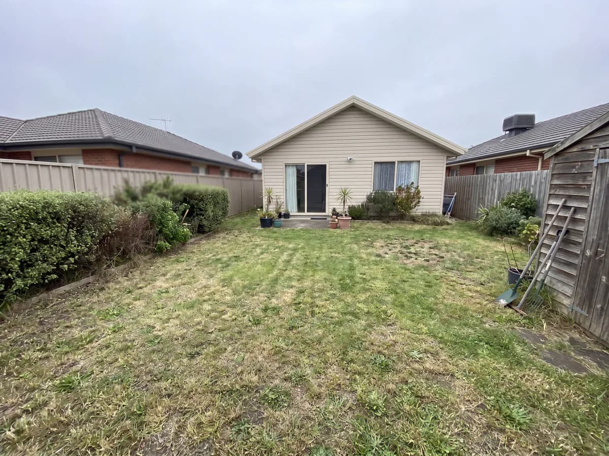 AI fence design before and after: a bare property line photo redesigned with a new fence.