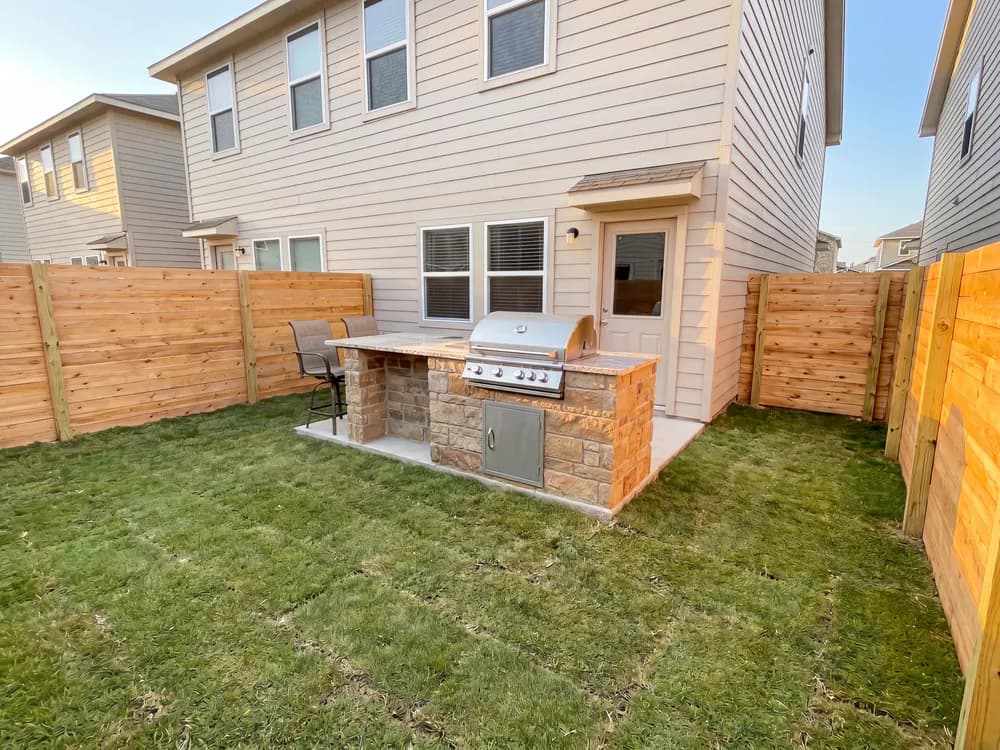 A backyard landscape design generated by OutdoorBrite from the owner's photo