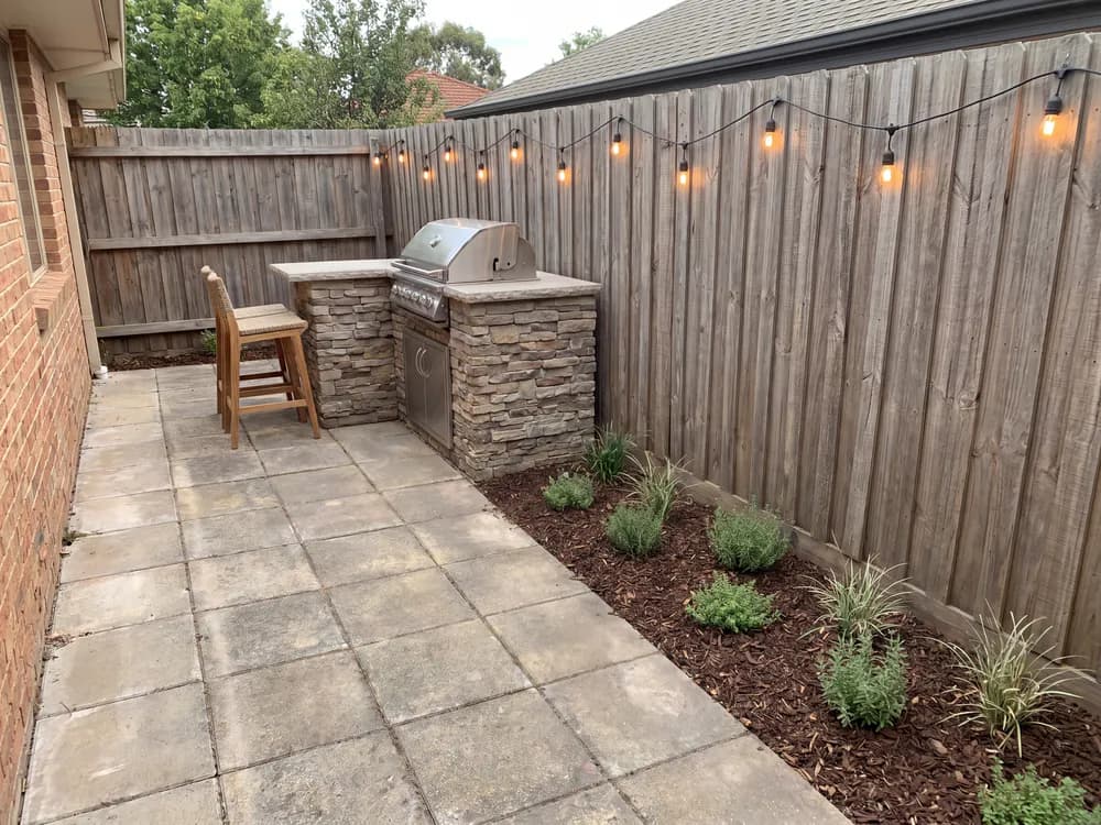 A backyard landscape design generated by OutdoorBrite from the owner's photo