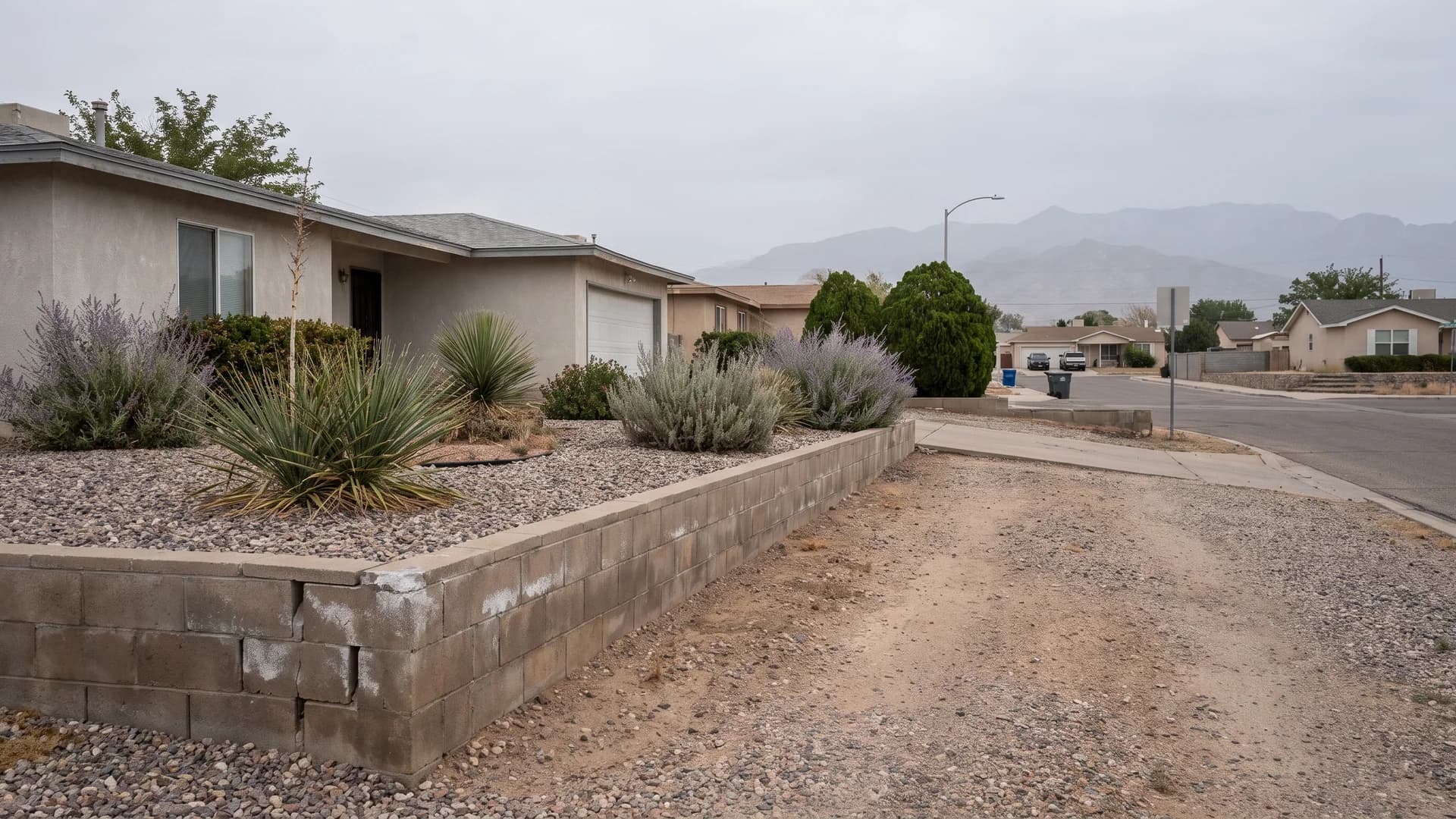 Low block terrace wall holding a gravel bed on a gently sloped front yard