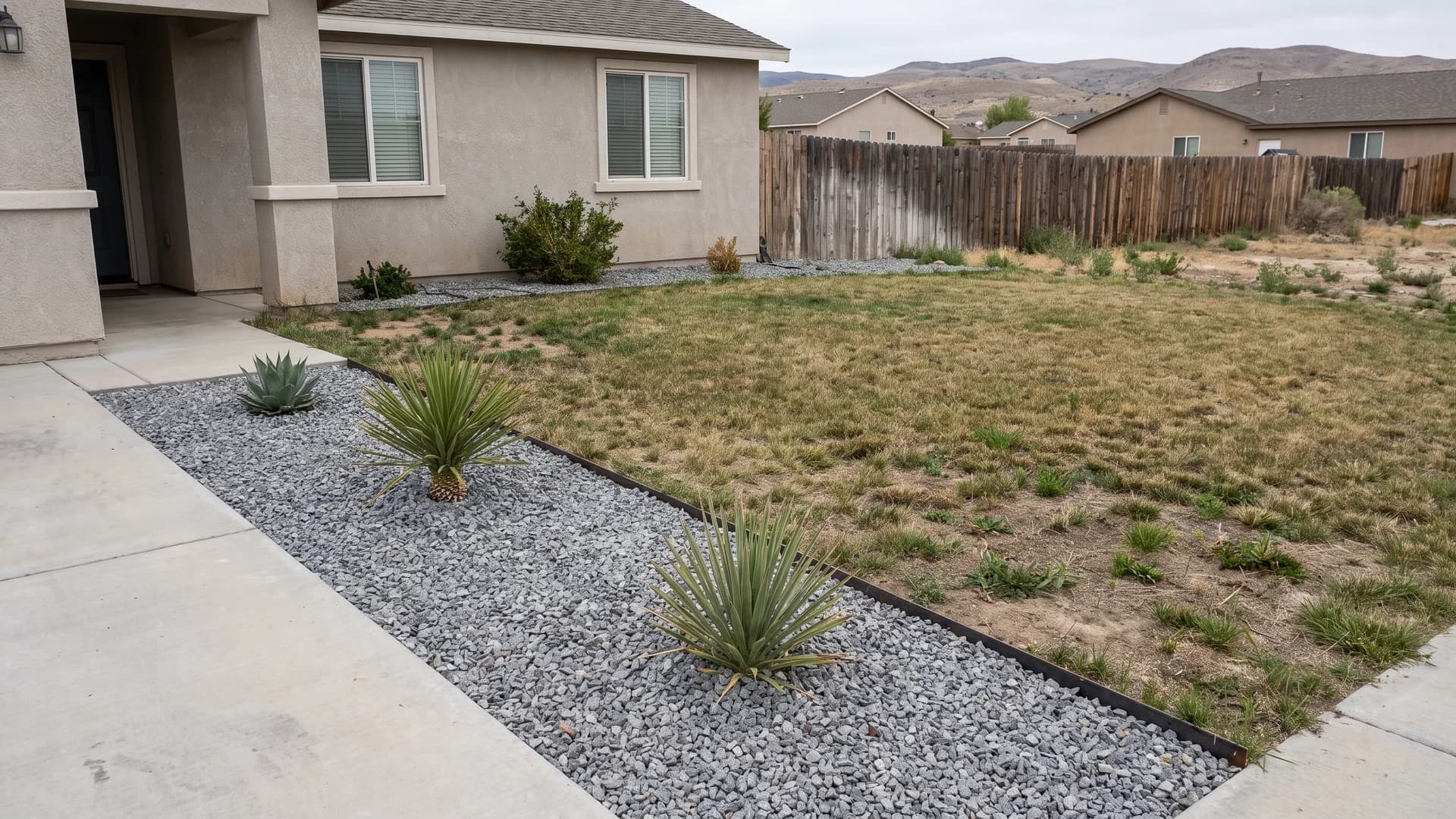 Half-converted front yard with one gravel and plant strip finished beside remaining lawn