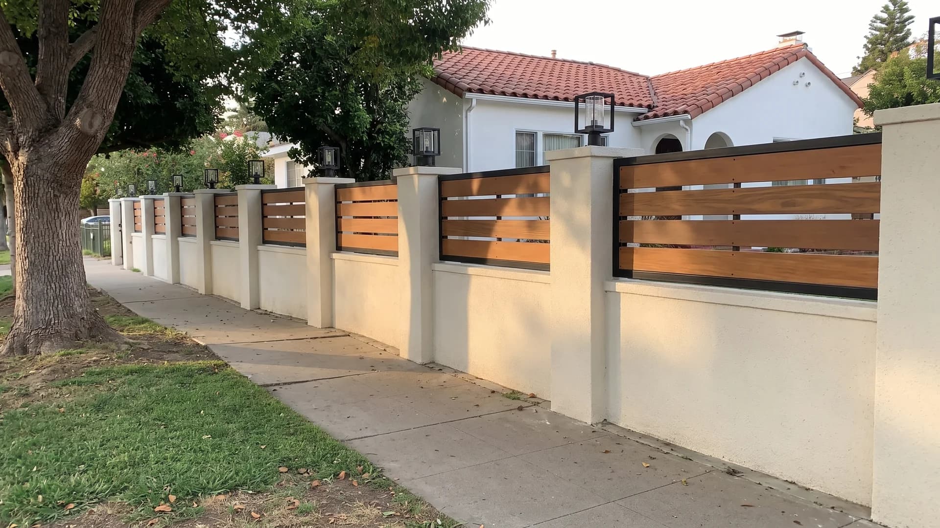 Honey hardwood horizontal slat panels set in black frames between cream stucco pillars
