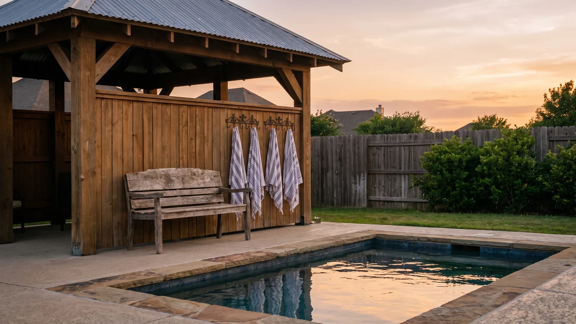 Small cabana corner with a bench and roof beside a backyard pool
